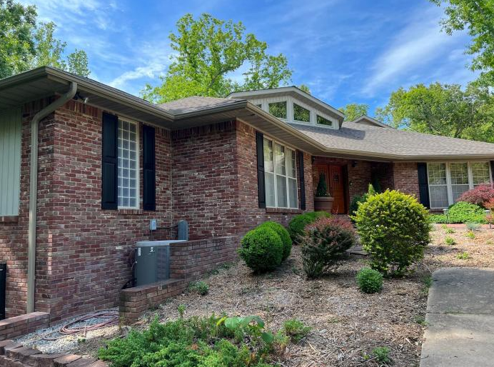 tan gutters and downspouts on brick home