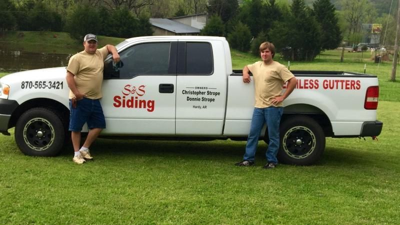 S&S Siding & Seamless gutters crew in front of truck