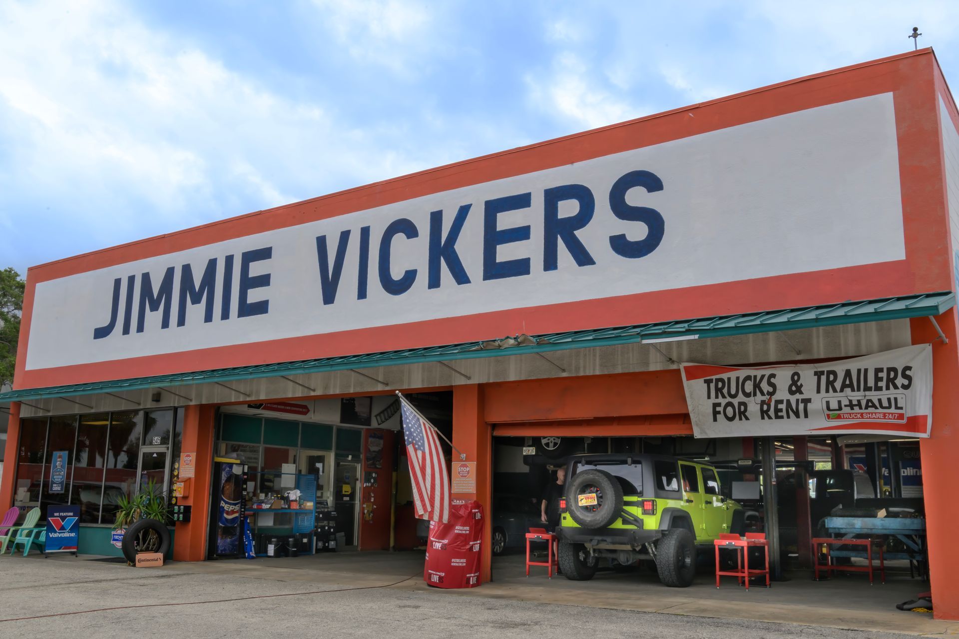 Jimmie Vickers storefront with truck and trailer rental signage and vehicles parked outside