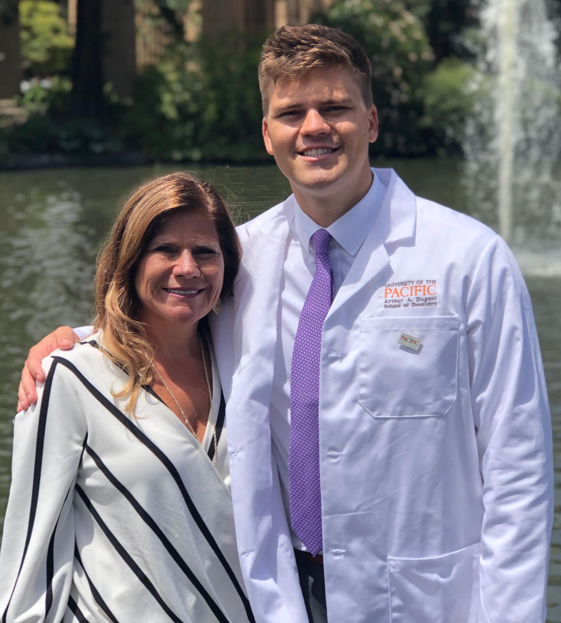 A man in a lab coat stands next to a woman