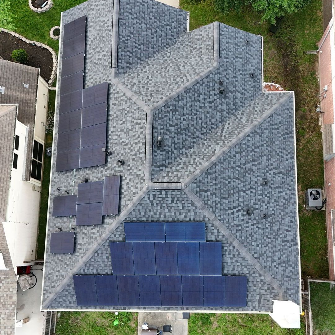 Aerial view of a residential asphalt shingle and solar panel installation in Denver, CO