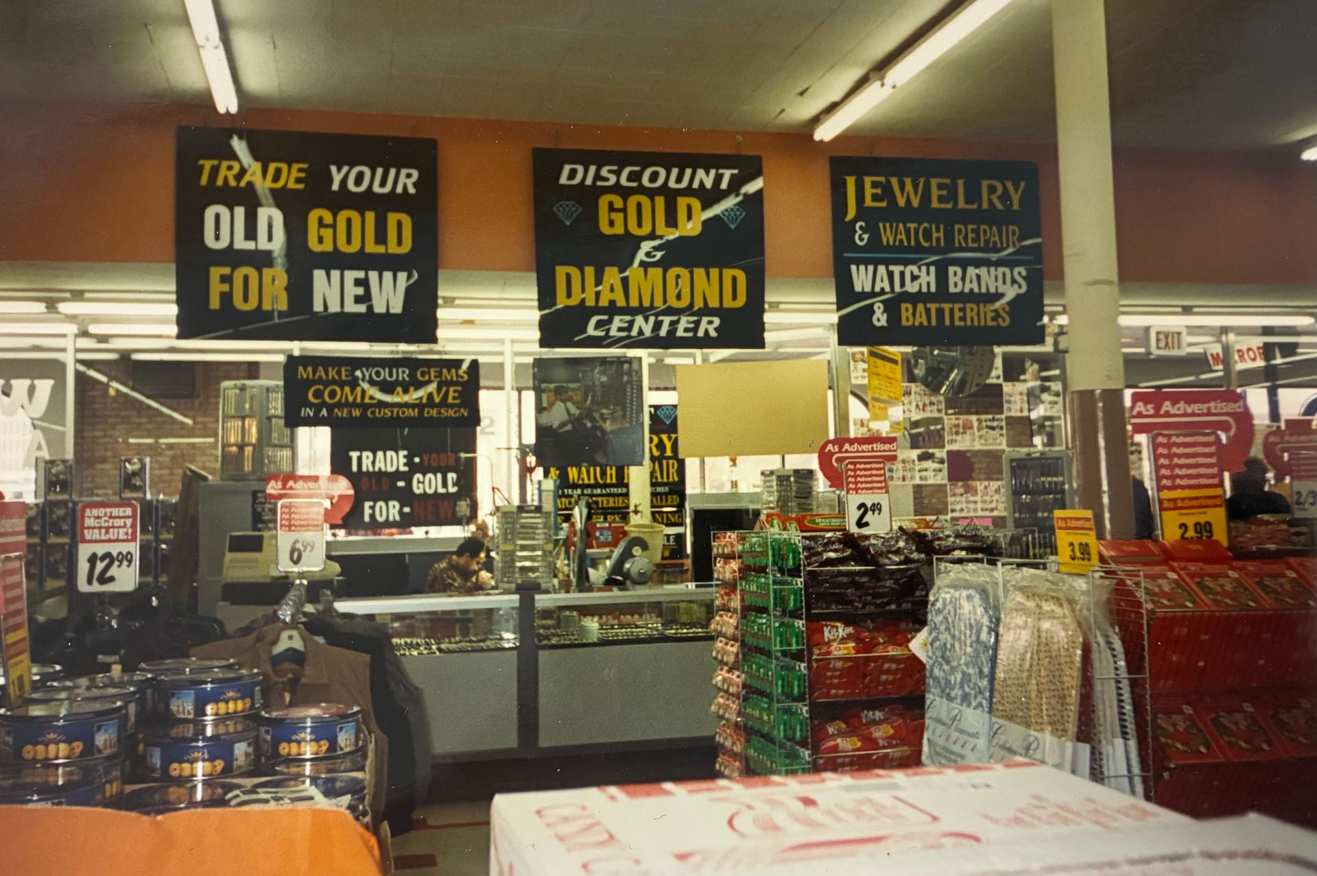Pawn shop counter with signs advertising gold, diamonds, jewelry, and watch battery services