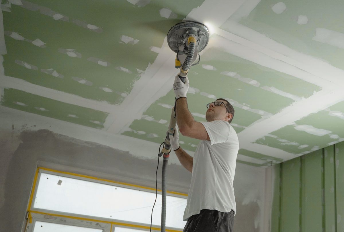 Contractor patching damaged ceiling drywall in Hanford, CA