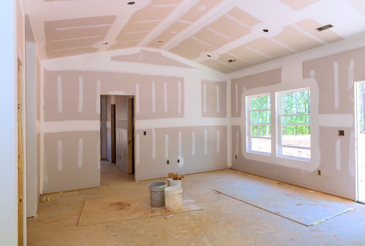 Technician hanging drywall sheets on wall framing in Hanford, CA