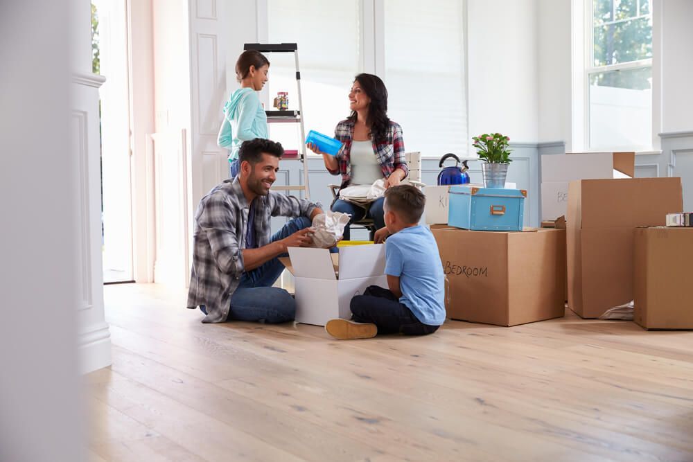 A Family is Sitting on the Floor in a Living Room — A-Team Delivery Services Pty Ltd in Cessnock, NSW
