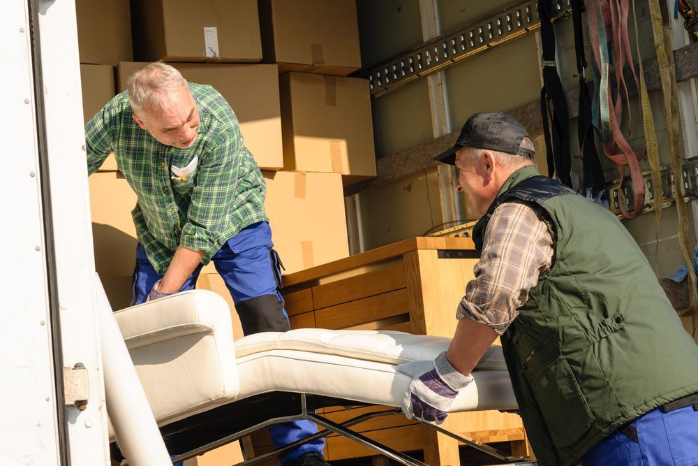 Two Men Are Loading a Couch Into a Truck — A-Team Delivery Services Pty Ltd in Cessnock, NSW