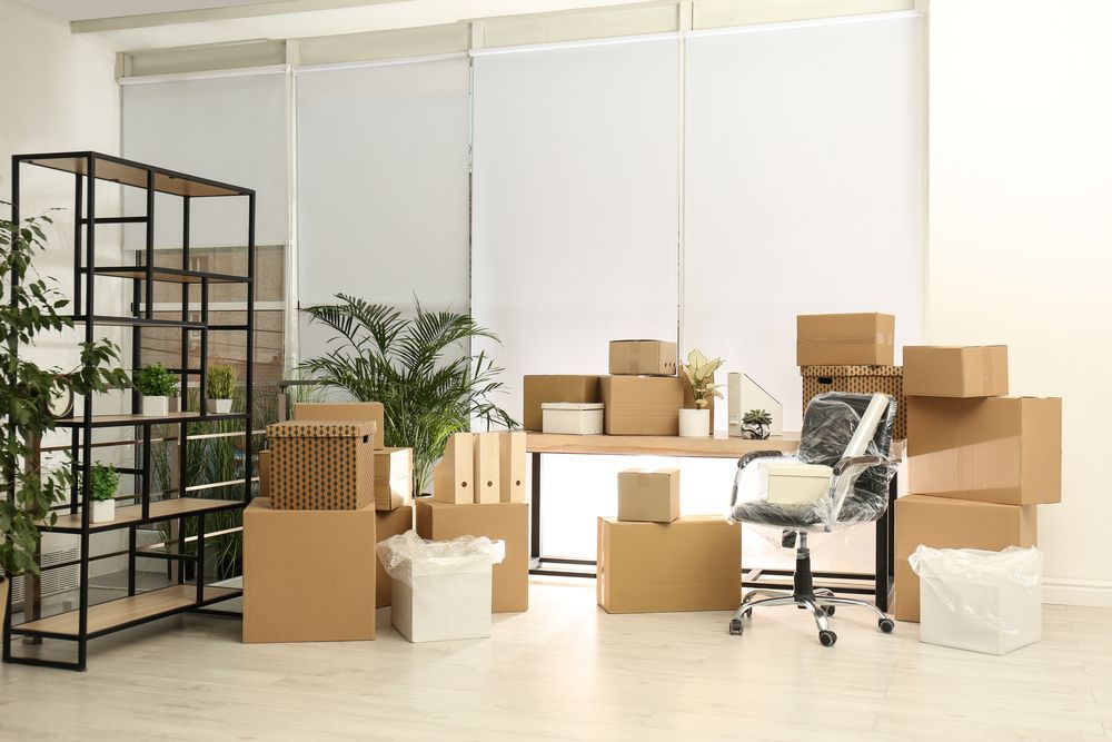 A Room Filled With Lots of Cardboard Boxes and Furniture — A-Team Delivery Services Pty Ltd in Newcastle, NSW