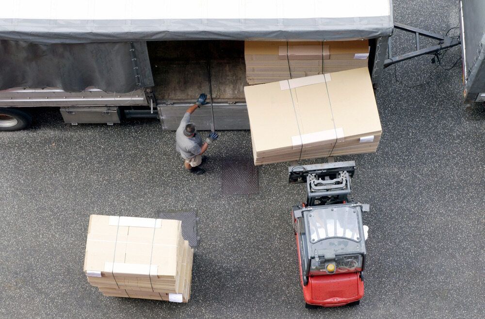 An Aerial View of a Man Loading Boxes Into a Truck — A-Team Delivery Services Pty Ltd in Singleton, NSW