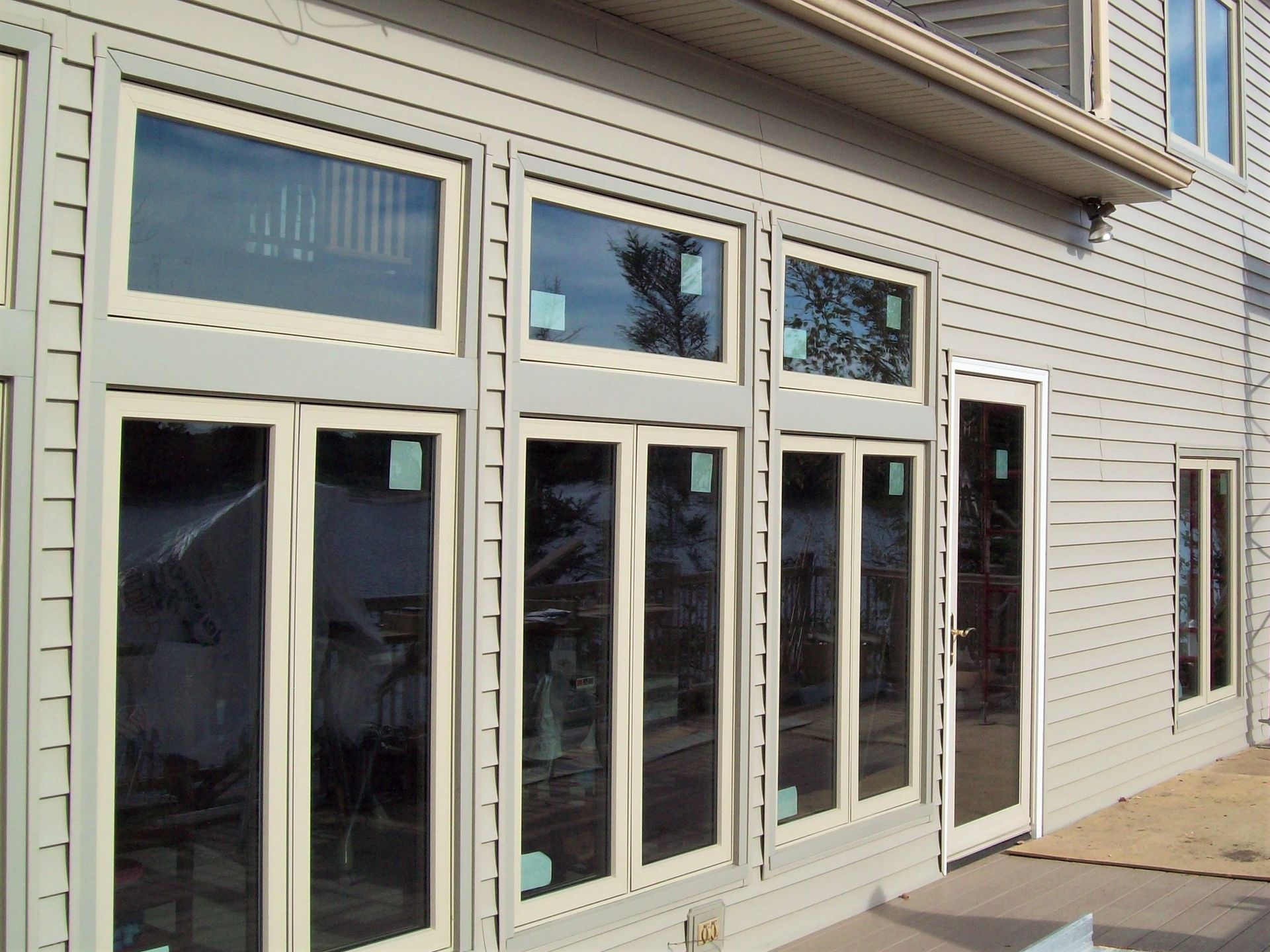 Storefront with white-framed glass doors and windows on a beige building exterior