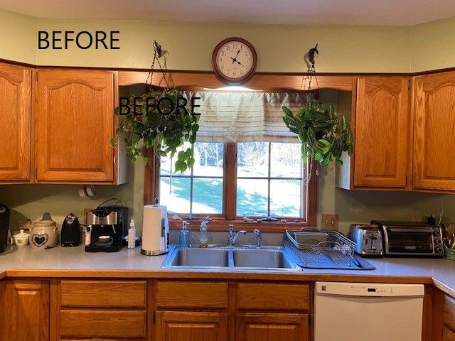 Before photo of a kitchen with wooden cabinets, window above sink, and countertop appliances
