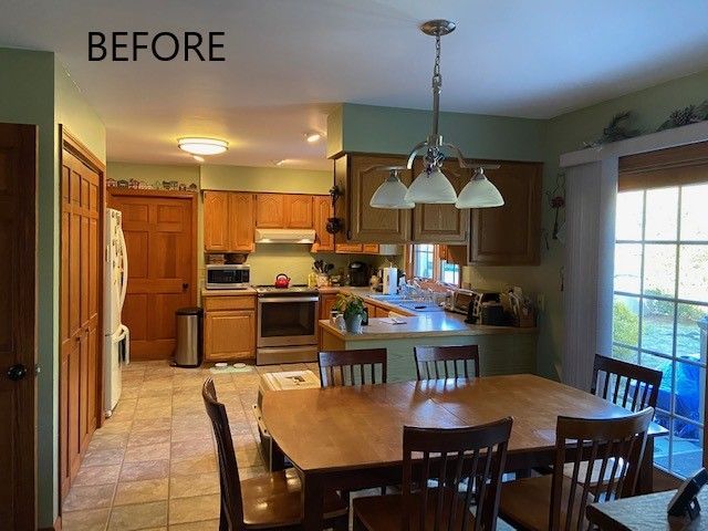 Before view of a warm kitchen and dining area with wooden cabinets, a table, and hanging light fixture.