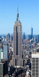 Empire State Building towering over Manhattan skyline under a clear blue sky