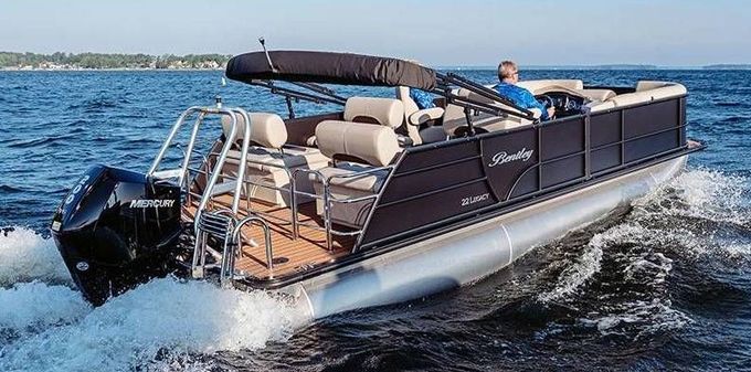 A pontoon boat is floating on top of a body of water.