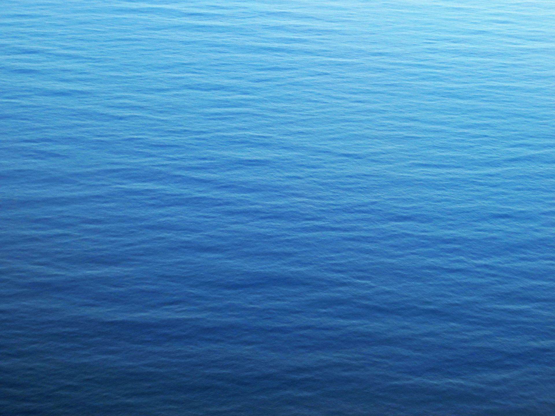 A close up of a blue water surface with waves
