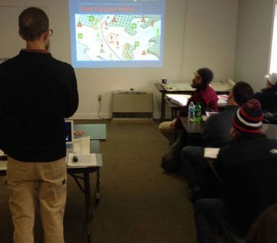 A man is giving a presentation to a group of people