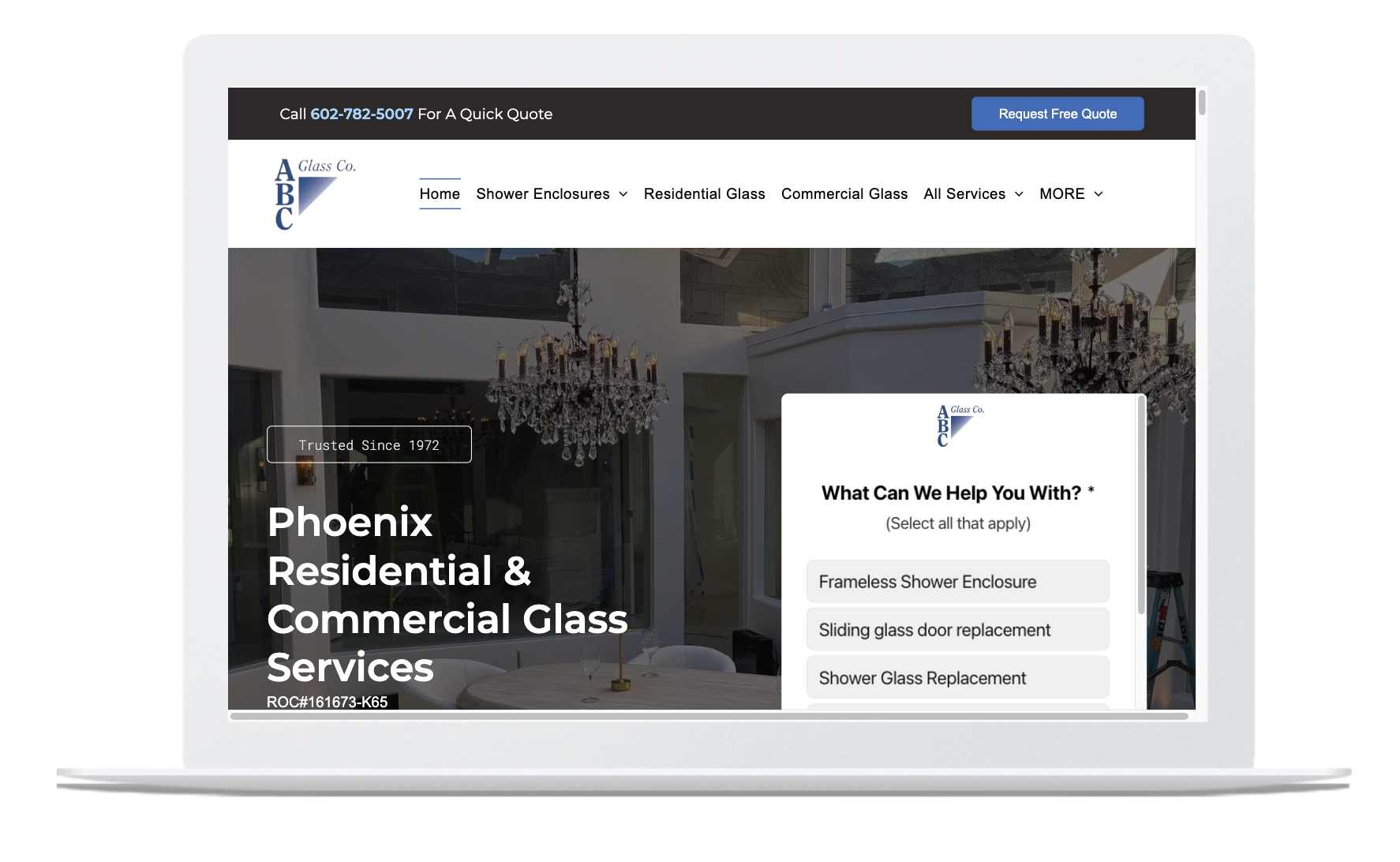 Laptop displaying a residential and commercial cleaning services website homepage with a chandelier interior background