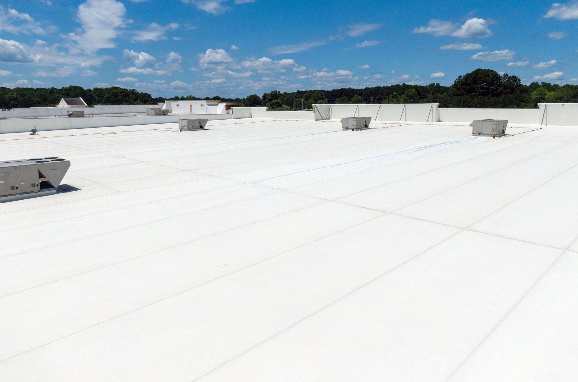 A large white roof with a blue sky in the background.