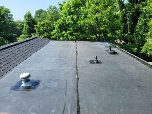 Black EPDM roofing membrane over flat roof section