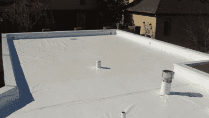 A white PVC membrane roof with a chimney on top of it.