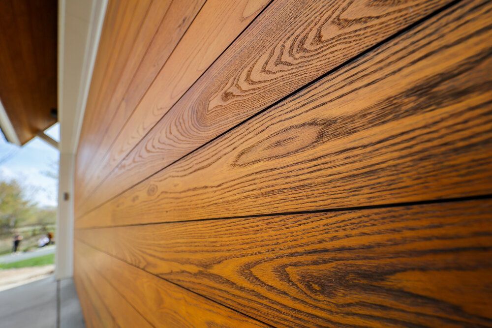 A close up of a wooden siding on a house.