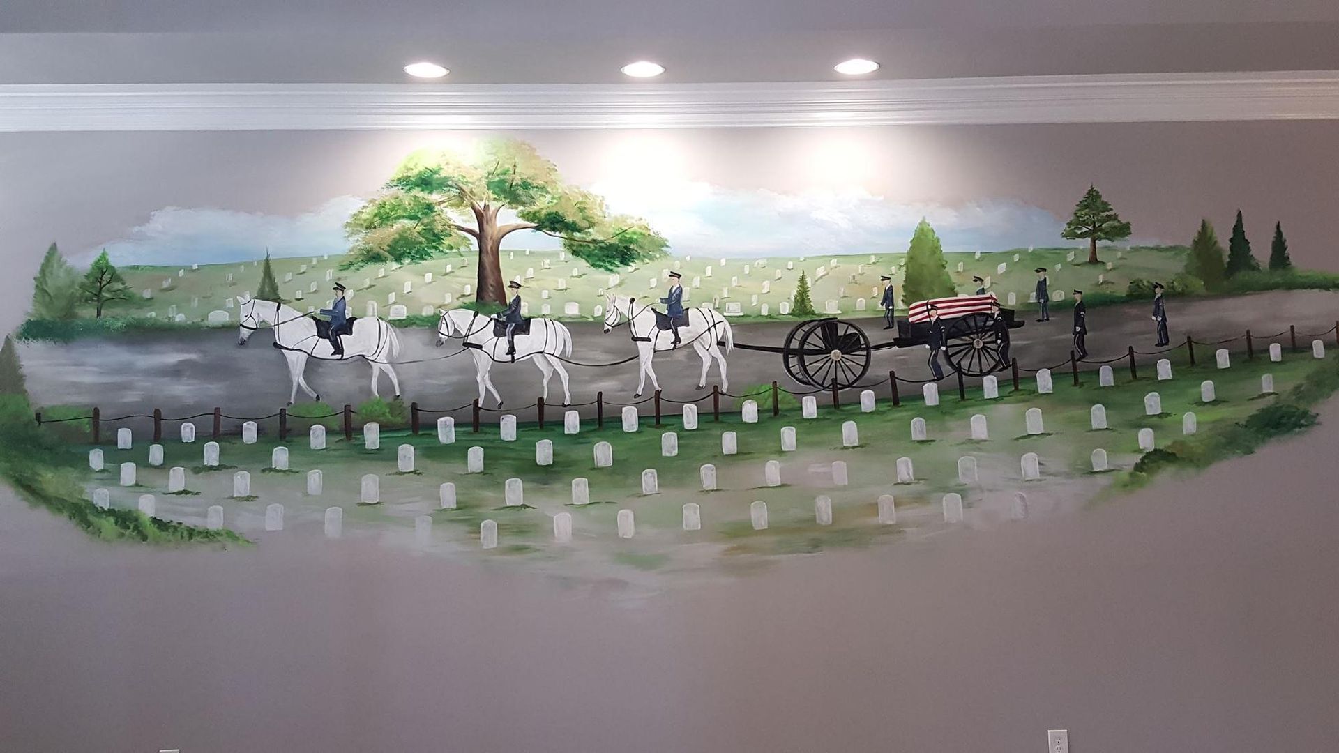 Mural of horse-drawn hearse and riders in a cemetery, along a road, with green trees and white grave markers.