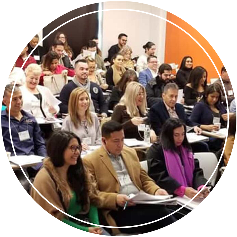 A group of people attending a classroom lecture, with diverse faces and expressions.