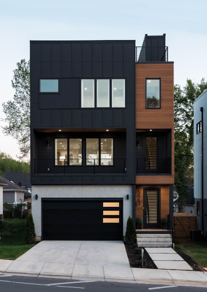 Modern three-story house with black and wood siding, a concrete driveway, and a black garage door.