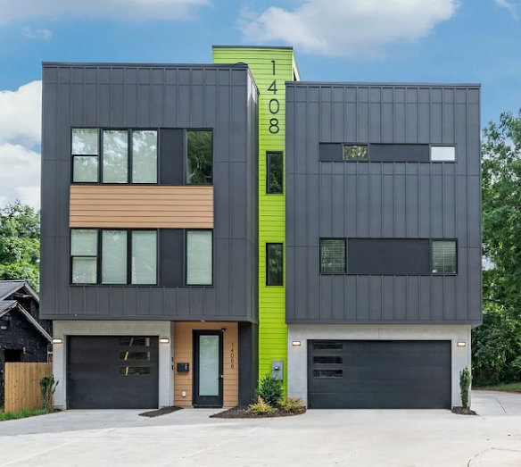 Modern two-story house with dark gray siding, light green accent, and two garages. Address 1408 on the facade.