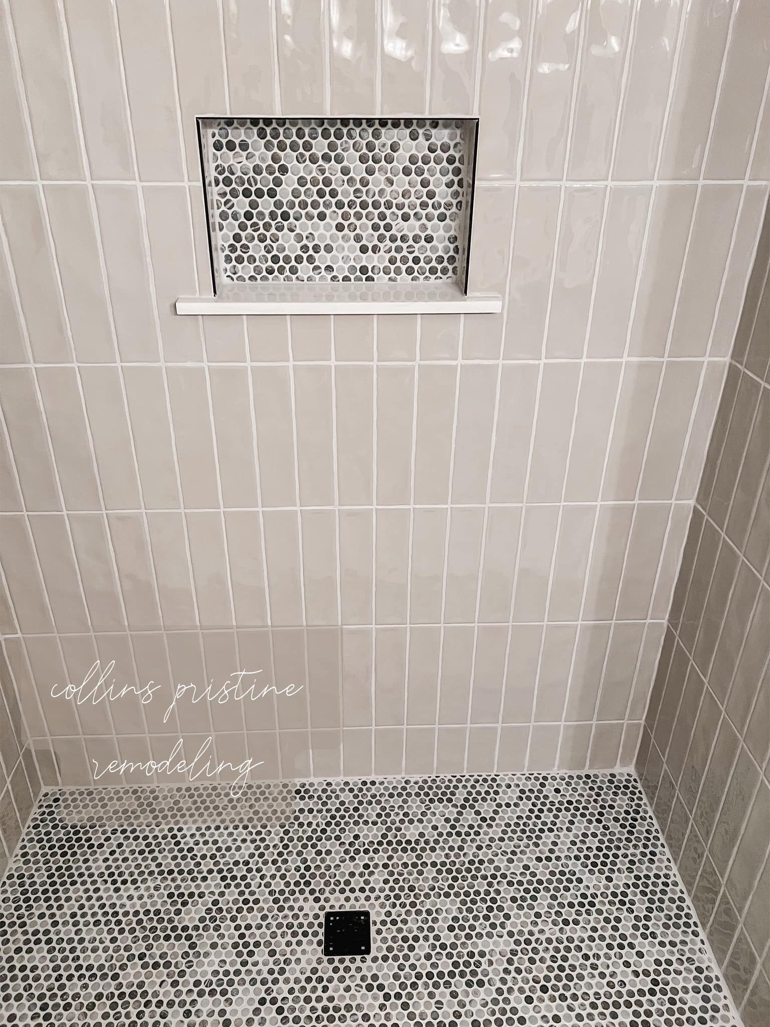 Tiled shower corner with a small window and a central floor drain