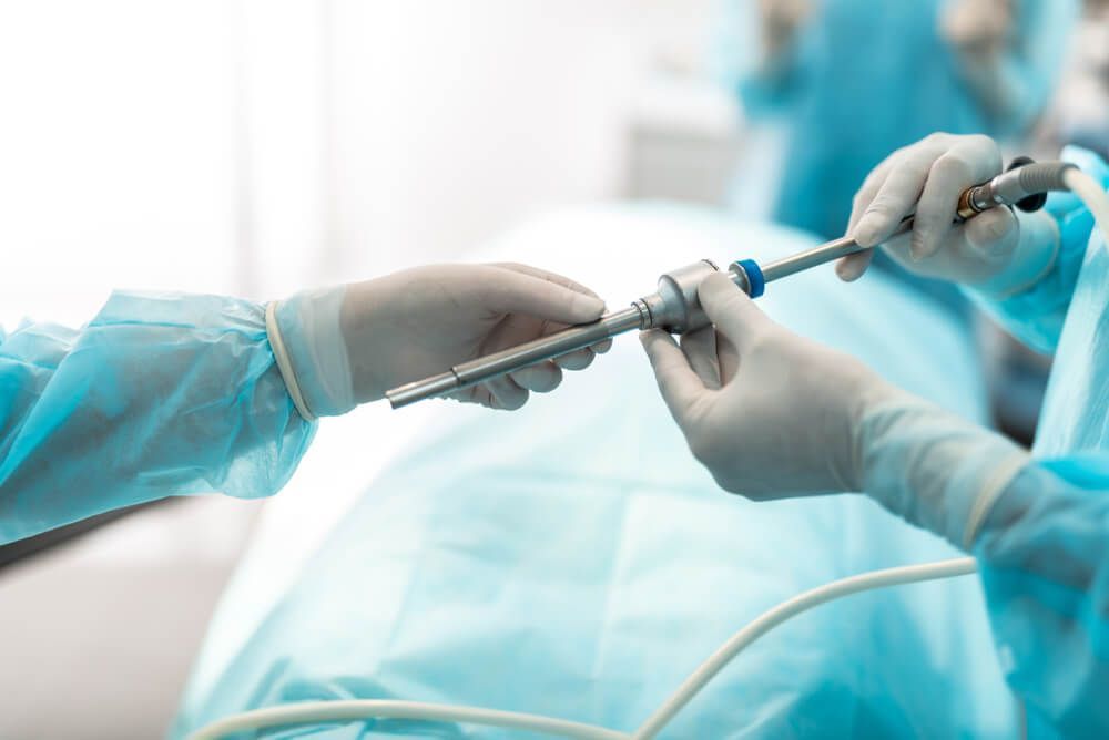 A Surgeon is Holding a Surgeon Equipment With Assistant Surgeon — Brisbane Upper GI Surgery in Chermside, QLD