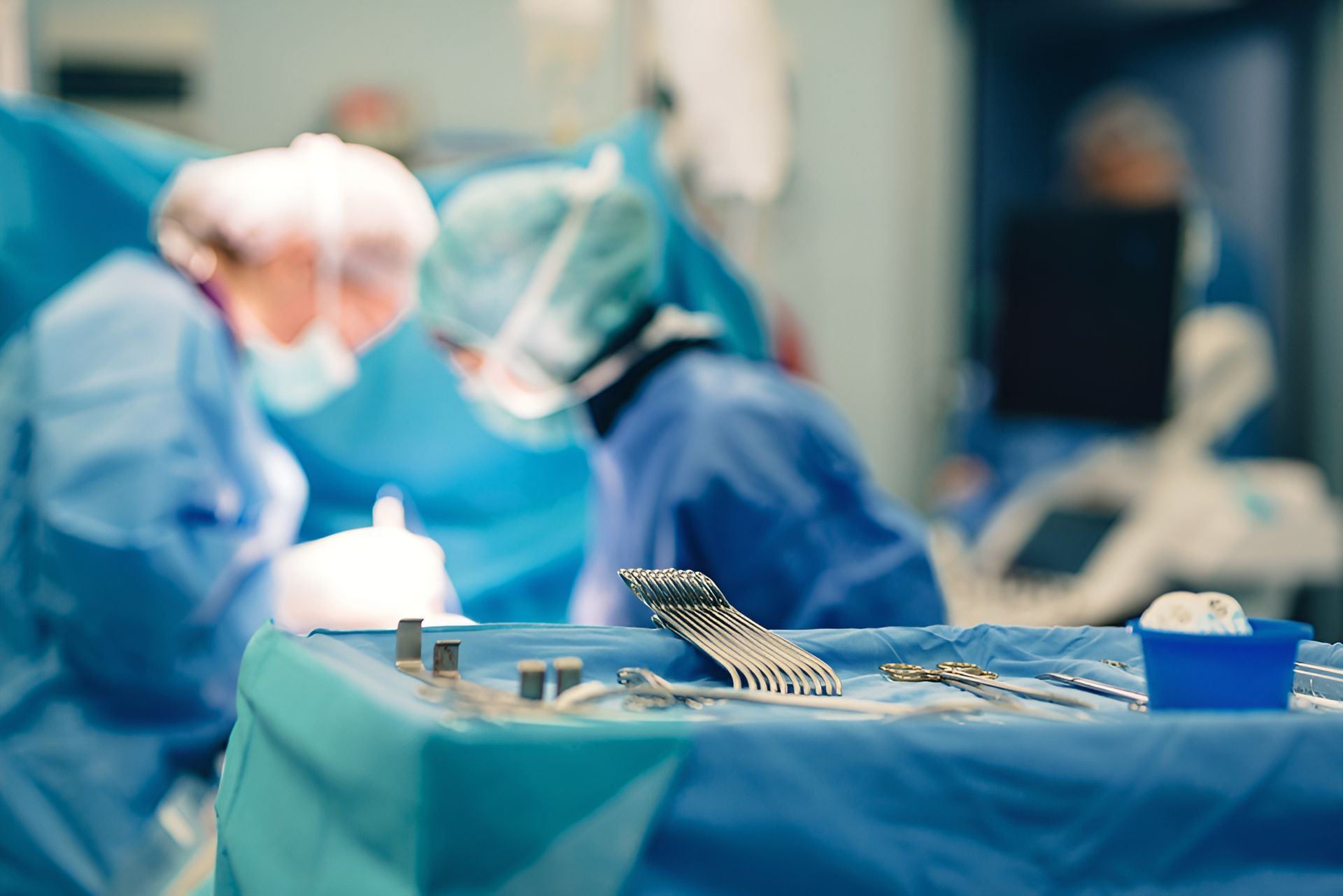 Surgical Team In Blue Scrubs Operating In A Sterile Environment, Instruments In Foreground — Brisbane Upper GI Surgery in Chermside, QLD