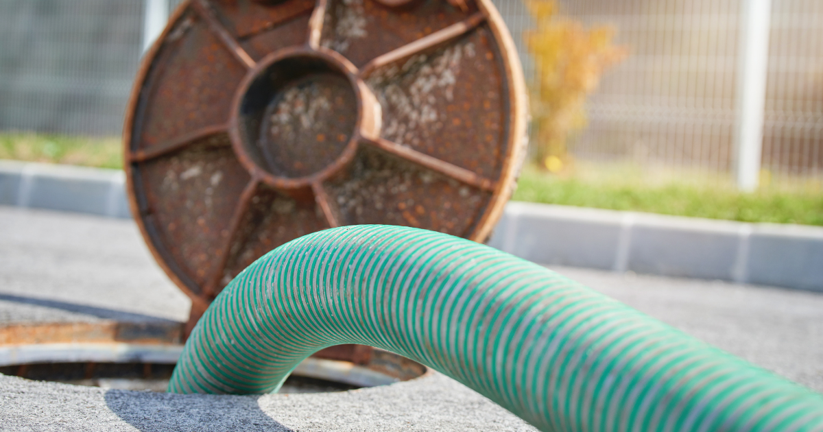 Super sucker hose down a manhole to vacuum debris.