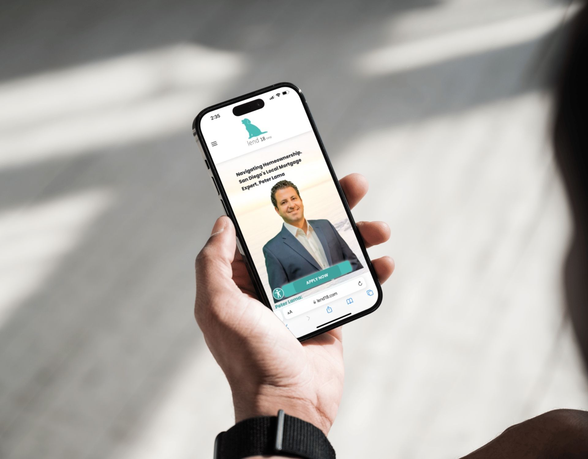 A person is holding a cell phone with a picture of a man on the screen.