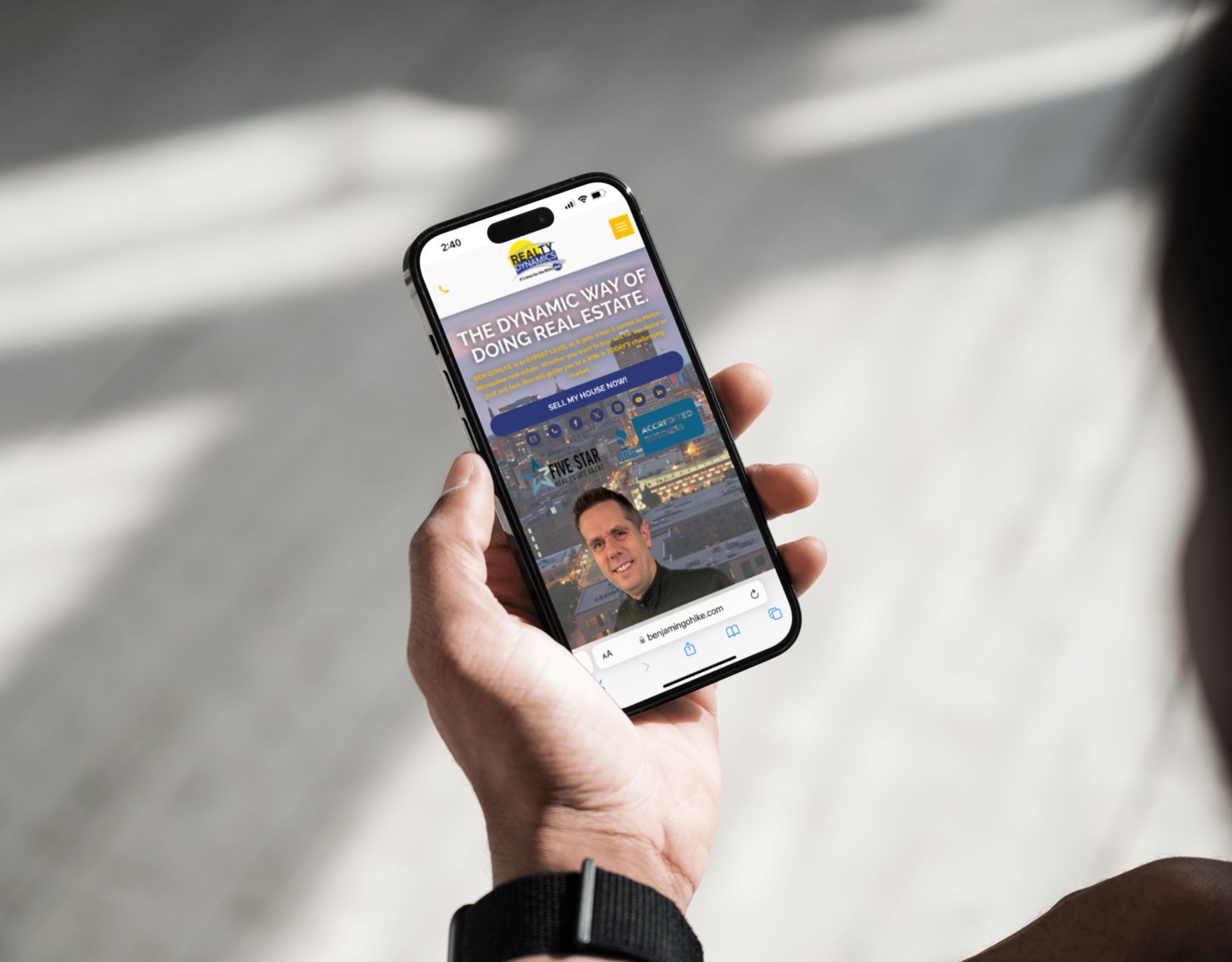 A person is holding a cell phone in their hand.