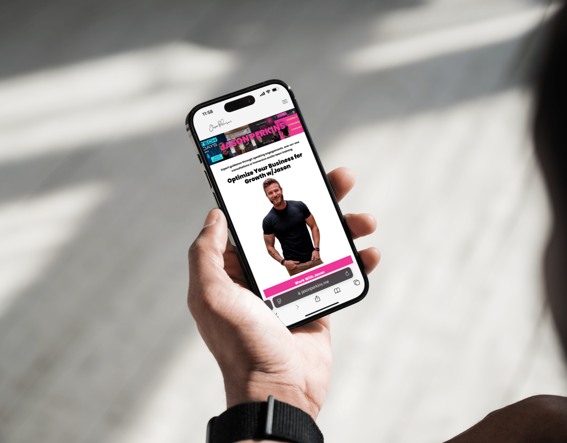A person is holding a cell phone with a picture of a man on the screen.