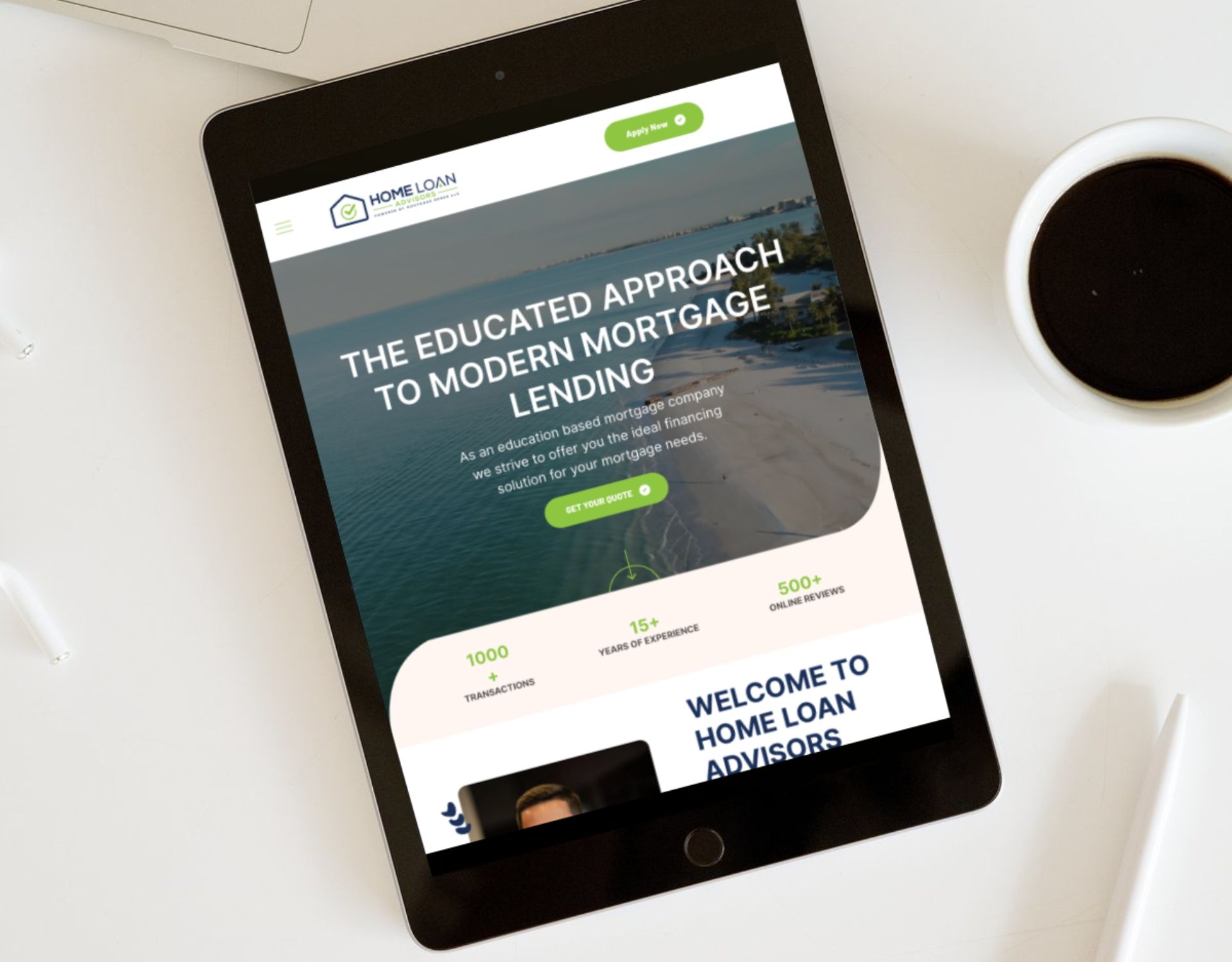 A tablet is sitting on a table next to a cup of coffee.