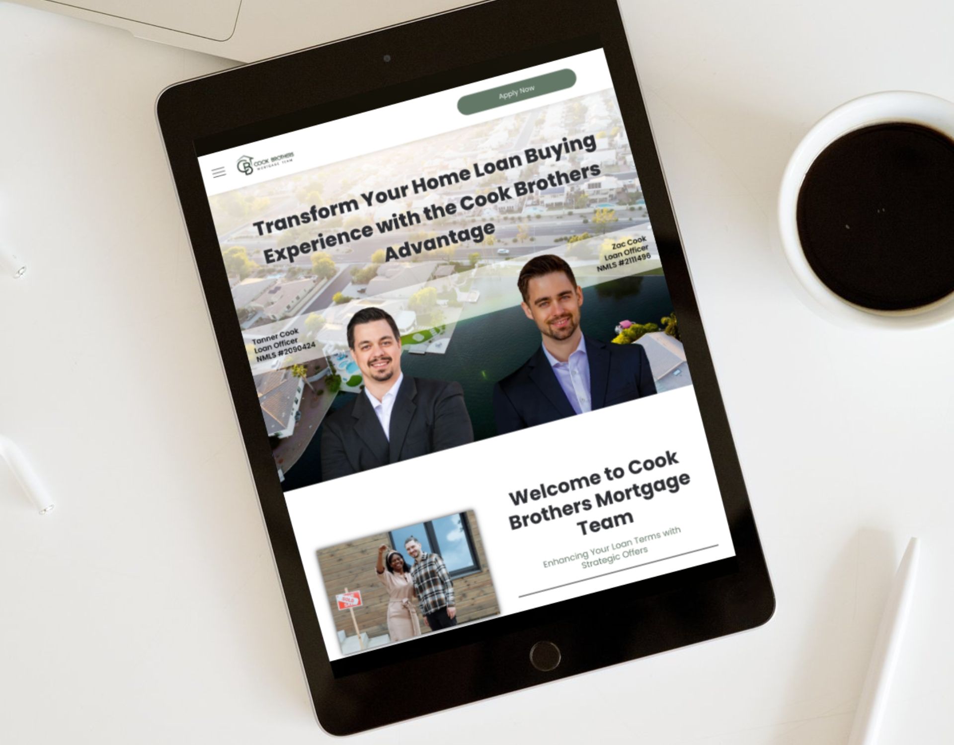 A tablet is sitting on a table next to a cup of coffee.