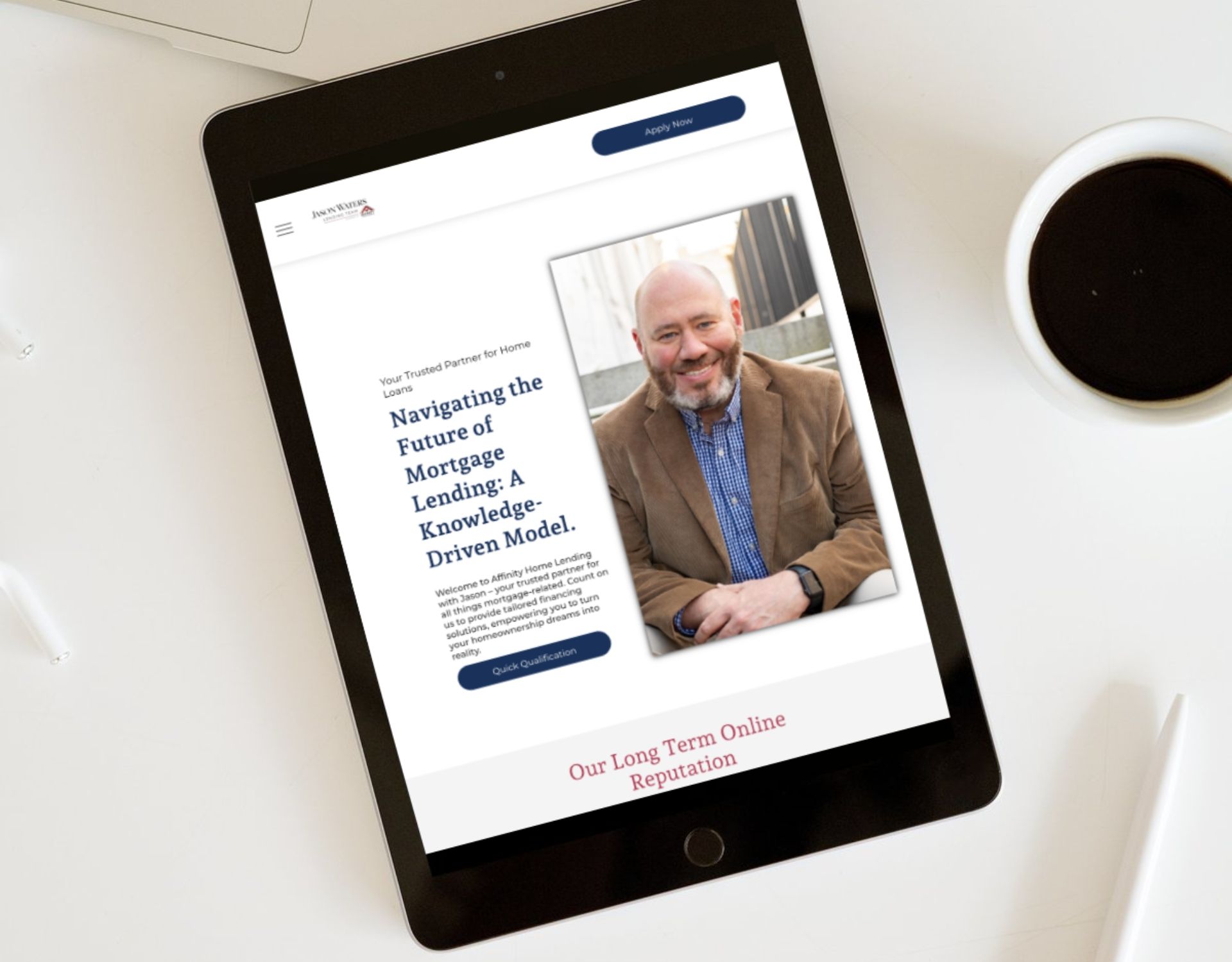 A tablet is sitting on a table next to a cup of coffee.
