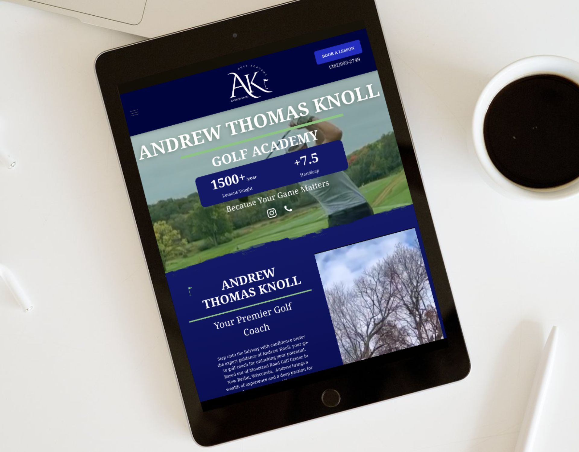 A tablet is sitting on a table next to a cup of coffee.