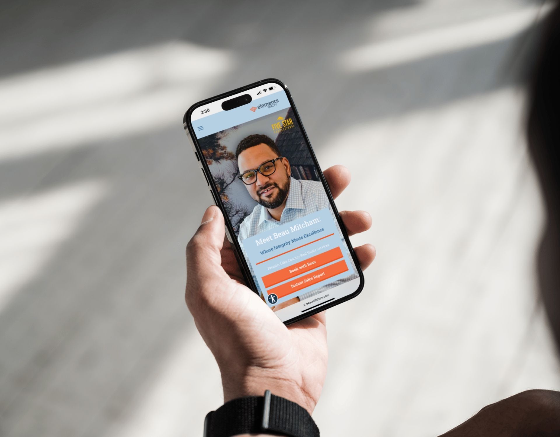 A person is holding a cell phone with a picture of a man on the screen.