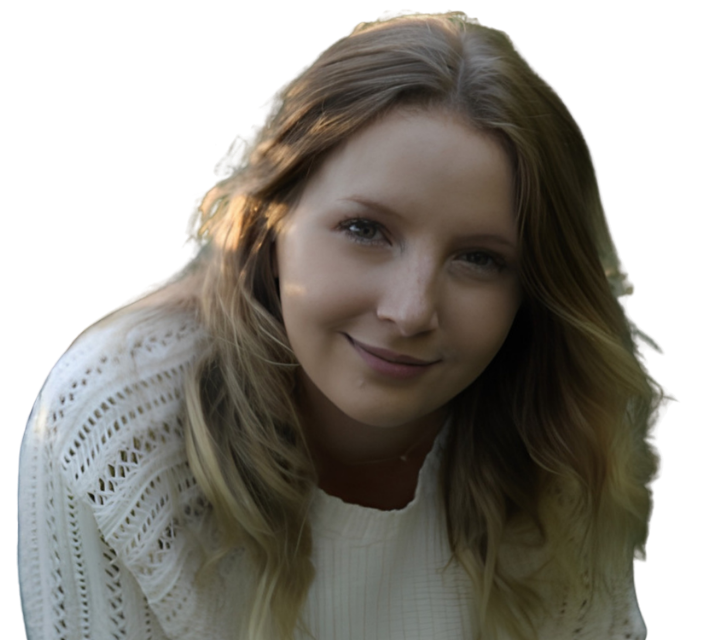 Woman smiling in a white sweater against a bright background