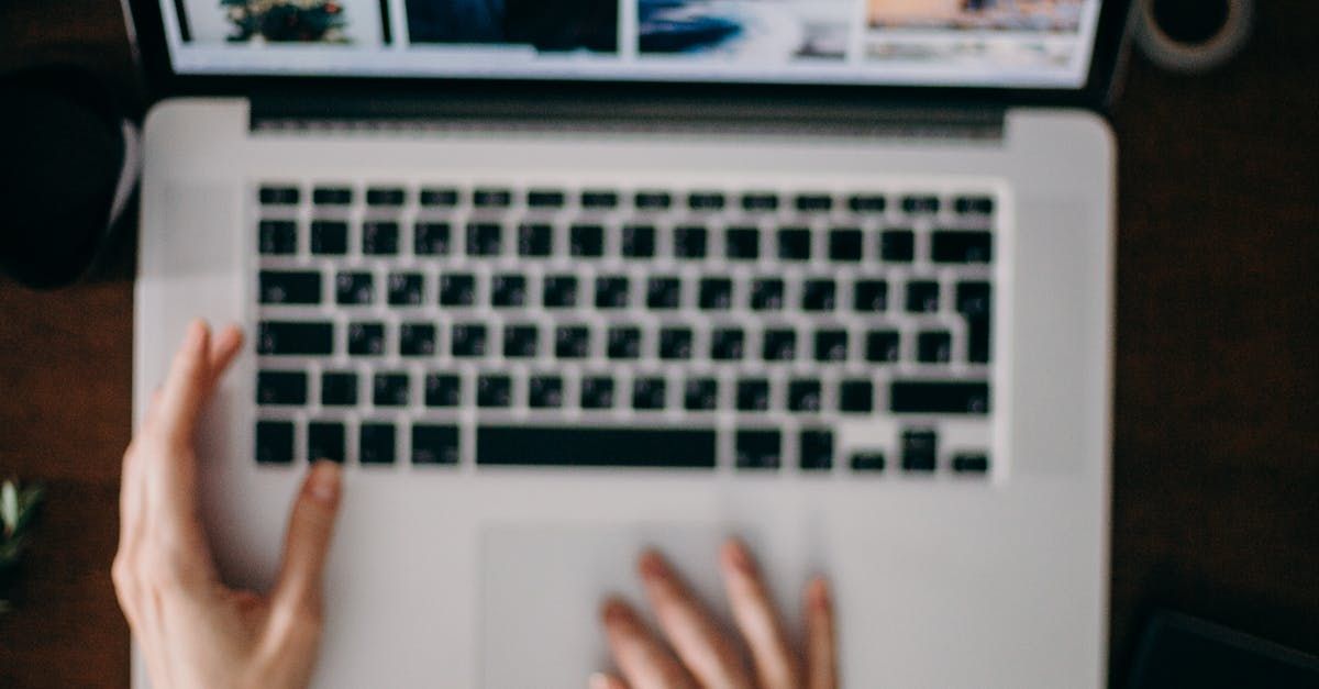 A person is typing on a laptop computer.