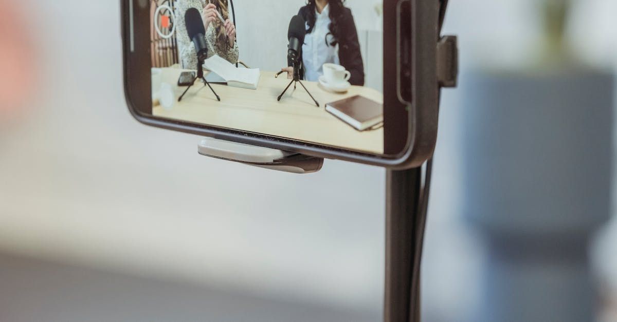 A close up of a cell phone on a tripod.