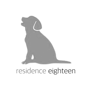 A silhouette of a dog sitting down with the words `` residence eighteen '' below it.