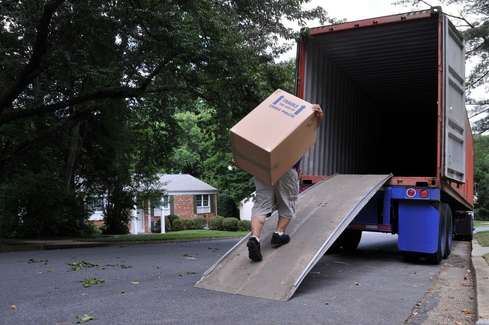 A Man Carrying Big Box — FNQ Furniture Removals in Cairns, QLD