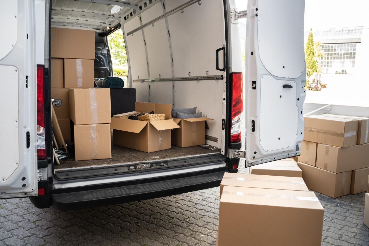 The Back of a Delivery Van is Filled With Cardboard Boxes — FNQ Furniture Removals in Innisfail, QLD