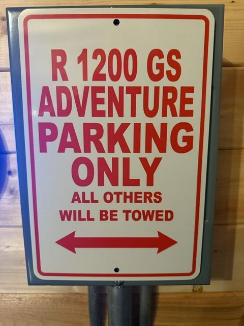 Red and white sign: “R 1200 GS Adventure Parking Only,” with “All others will be towed” and arrows.