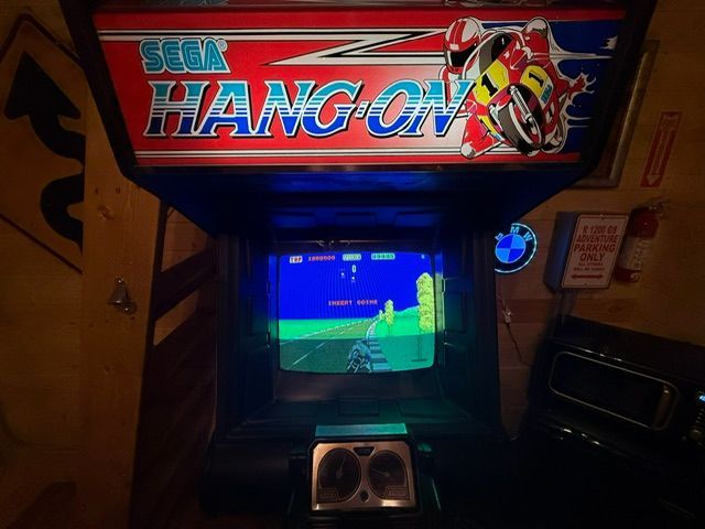 Sega Hang-On arcade cabinet with a motorcycle game screen and colorful marquee