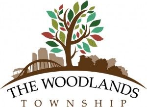 The Woodlands Township logo with a tree, leaves, and city skyline