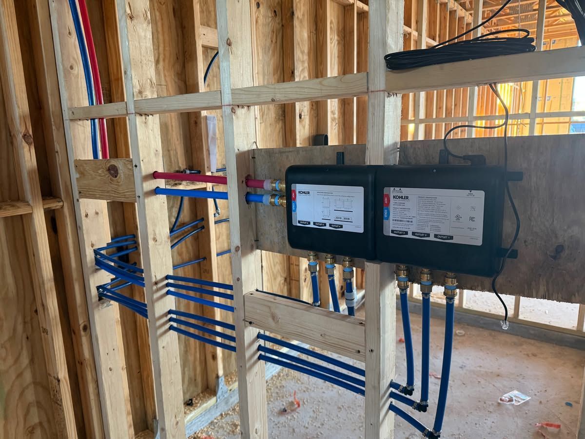 Electrical wiring and breaker panel installed in an unfinished house framing area.
